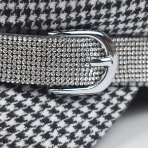 Fashionable houndstooth beret hat with shimmering rhinestone band and metal buckle detail