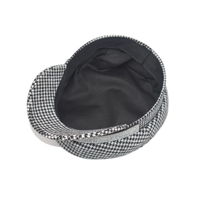 Detail of black and white houndstooth newsboy cap with sparkling rhinestone trim