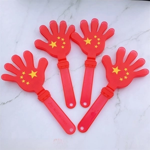 Vista dettagliata di quattro mani battimani in plastica rossa con stelle gialle su marmo