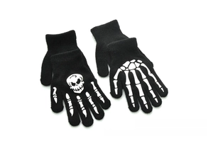 Close-up of knit winter gloves with glowing skeleton hand pattern for Halloween