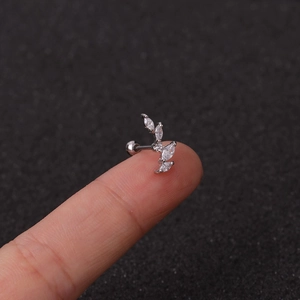 Detailed view of silver curved branch stud earring with marquise-cut zircon stones