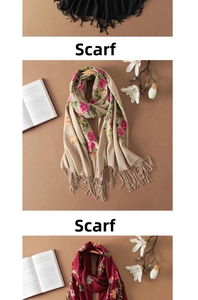 Detailed close-up of intricate floral silk embroidery on a soft cashmere-feel wool shawl