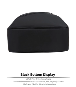 Detail view of the flat rectangular base of the black nylon bag showing seam craftsmanship