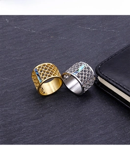 Detail of wide hollow honeycomb rings in gold and silver with blue abalone shell inlay