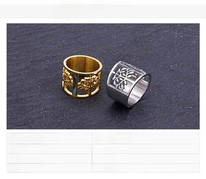 Macro detail of cut-out tree of life design rings in gold and silver stainless steel