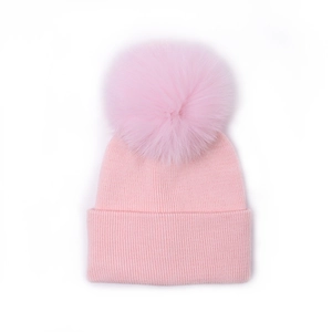 Pink knit baby beanie with large faux fur pompom and soft ribbed texture for kids