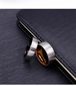 Detail of brushed titanium steel rings with two-tone inner bands on stone background