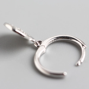 Polished S925 sterling silver hoop earring with hallmark stamp on gray background