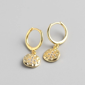 Detail of gold starburst coin drop earrings with micro-set zircons on s925 silver