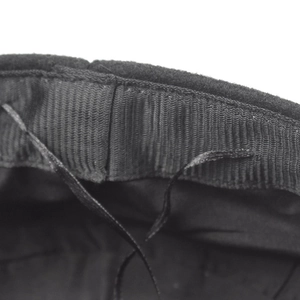 Black wool newsboy cap showing interior sweatband and adjustable drawstring detail