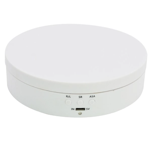 Close-up of white electric display turntable showing control buttons for speed and angle