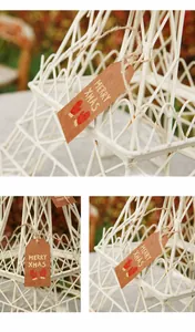 Detail view of mini kraft paper Christmas gift tags featuring Merry Xmas text and gloves