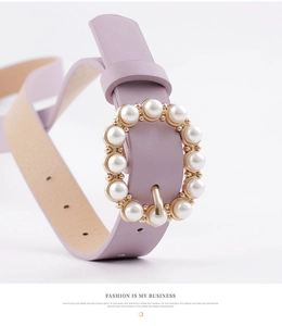 Close-up of a purple PU leather belt featuring a gold round buckle with inlaid pearls