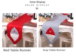 Detail of red and grey felt Christmas table runners with gnome star embroidery
