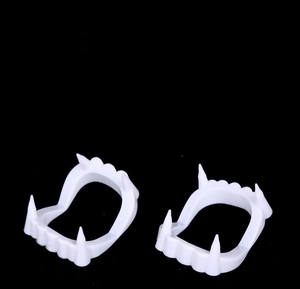 Detailed view of white plastic vampire fangs for Halloween zombie costumes, two-piece set