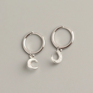 Close-up of S925 sterling silver moon earrings featuring sparkling inlaid diamonds