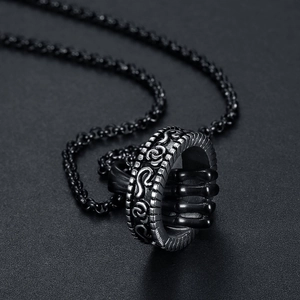 Detailed macro view of black steel ring pendant with retro ghost hand skeletal structure
