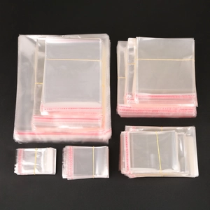 Various sizes of clear resealable poly bags for jewelry packaging on black background