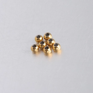 Detailed macro shot of 5mm golden stainless steel beads for DIY jewelry making