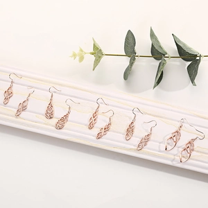 Detail view of 6 pairs of rose gold earrings with intricate vintage hollow patterns