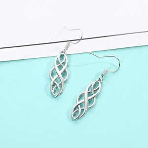 Detail of silver Celtic knot earrings featuring intricate geometric interlaced design
