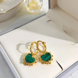 Elegant gold clover heart earrings with green stones in a premium jewelry box