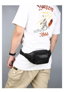 Detail view of black PU leather waist bag with multiple zipper pockets on a male model