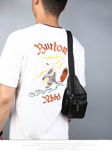 Rear view of model wearing a black PU leather chest bag with multiple zipper pockets