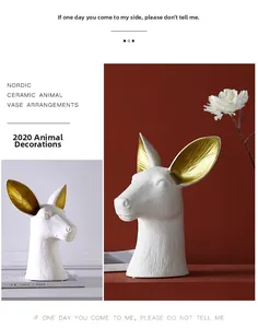 Detailed close-up of a white ceramic animal head vase with gold-textured inner ears