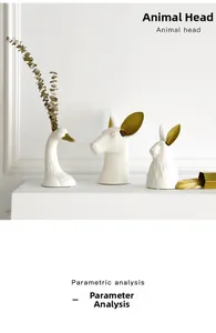 Detailed view of modern ceramic animal head vases in matte white with gold accents