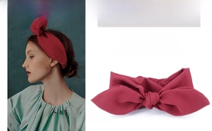 Detail of red rabbit ear headband showing knitted texture and high elastic structure