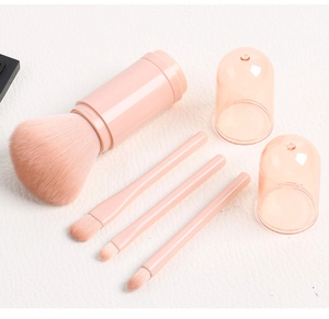 Pink 4-in-1 travel makeup brush set with large powder brush and three eye brushes