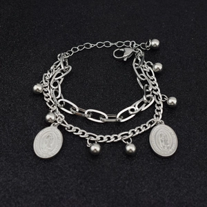 Detail of silver double-layered stainless steel bracelet with cross charms and beads