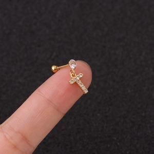 Detailed macro view of a gold screw back earring featuring a sparkling zircon letter T pendant