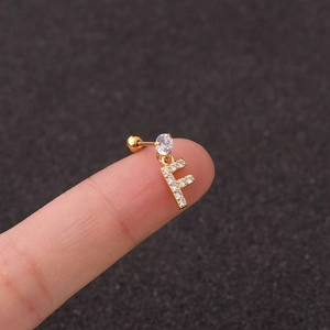 Macro view of gold zircon-inlaid letter F stud earring with a secure screw back