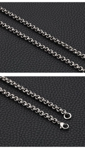Detail of silver-gray stainless steel chain with secure lobster clasp on black leather