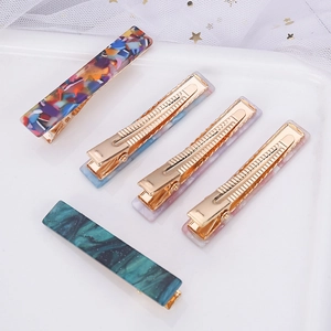 Rectangle acetate leopard marble hair clips with gold metal base on white mesh background