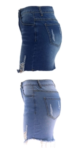 Detailed view of distressed denim skirts featuring ripped hems and whisker patterns