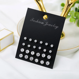 Set of 12 pairs of sparkling cubic zirconia stud earrings in various sizes on a black card
