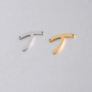 Macro view of polished silver and gold wishbone connector charms for jewelry making