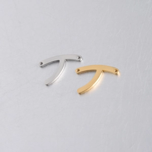 Close-up of gold and silver polished wishbone necklace connectors for DIY jewelry