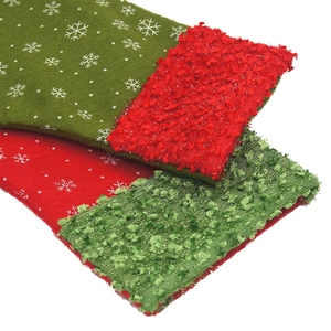 Close-up of red and green Christmas stockings with snowflake patterns and soft cuff textures