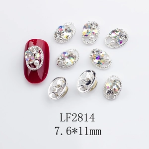 Detailed view of silver oval nail jewelry with K9 crystals and pearls size 7.6x11mm