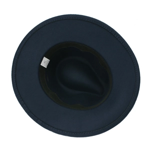 Detailed interior view of a navy blue fedora hat showing material tag and sweatband