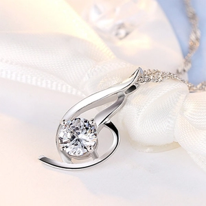 Elegant silver angel wing pendant necklace with a brilliant round zircon on white silk