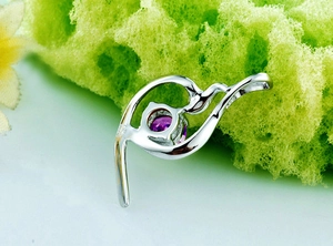 Macro shot of S925 hallmark on the silver pendant with purple gemstone detail