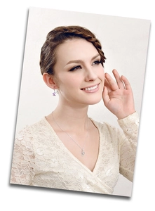 Close-up of elegant water-drop necklace and purple flower-shaped earrings on a model