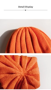 Close-up of orange ribbed knit beanie showing high-quality stitching and texture