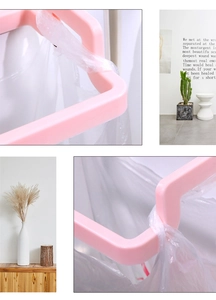 Pink plastic over-door garbage bag holder and towel rack for kitchen cabinets