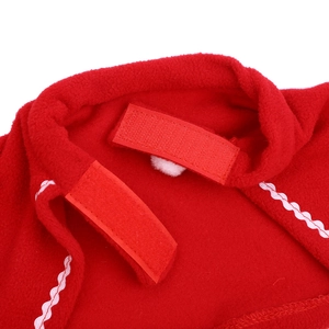 Detail of red fleece pet cloak with velcro fastener and decorative white wavy stitching